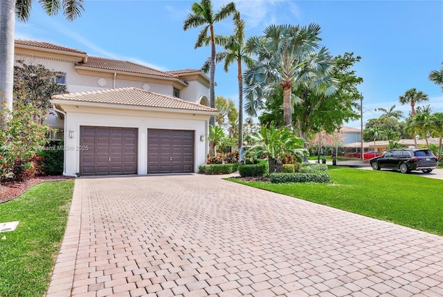 mediterranean / spanish home with a front yard