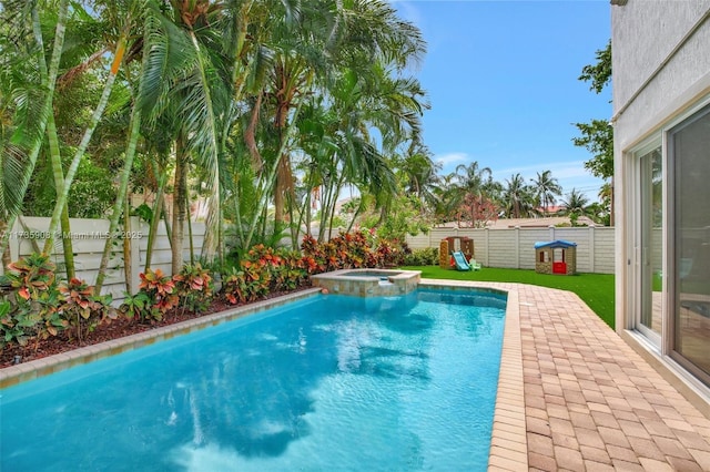 view of swimming pool with a patio and an in ground hot tub