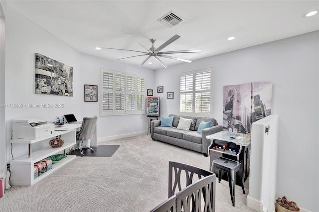 carpeted office featuring ceiling fan