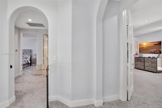 hallway with light colored carpet