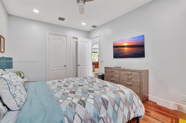 bedroom with ceiling fan and light hardwood / wood-style floors