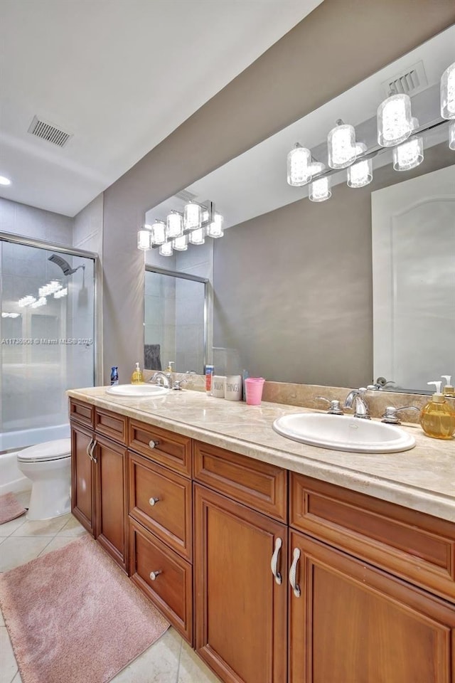 full bathroom with enclosed tub / shower combo, tile patterned floors, toilet, and vanity