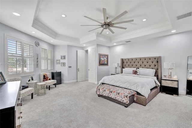 bedroom with a raised ceiling, ornamental molding, light colored carpet, and ceiling fan