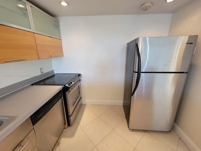 kitchen with appliances with stainless steel finishes and light tile patterned floors