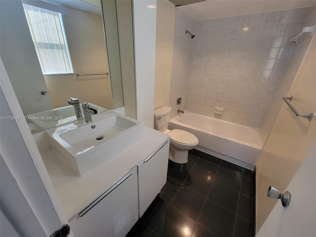 full bathroom with vanity, tile patterned flooring, toilet, and tiled shower / bath