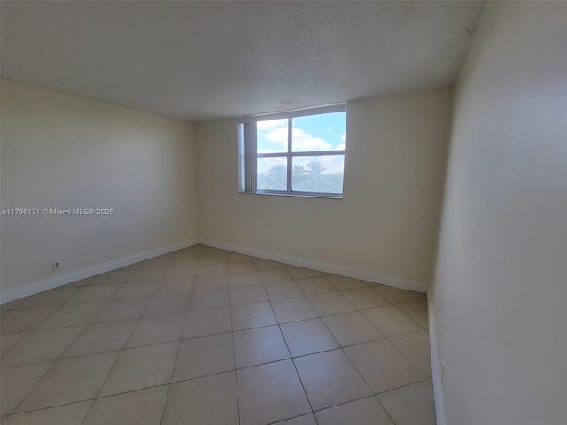 unfurnished room with a textured ceiling