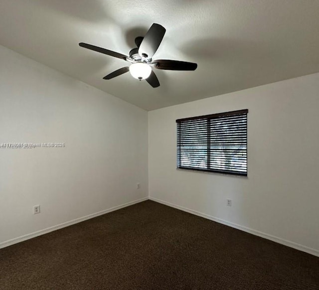 unfurnished room featuring ceiling fan and dark colored carpet