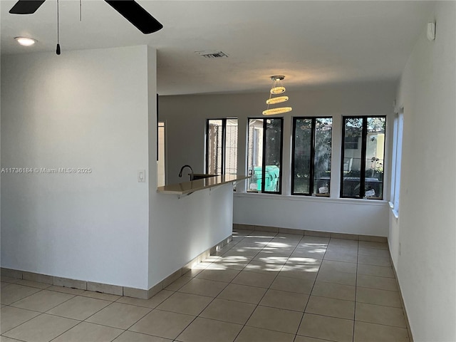 unfurnished room featuring ceiling fan and light tile patterned floors