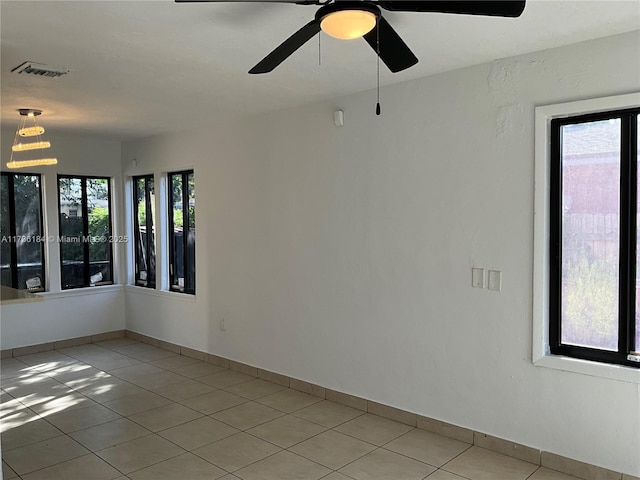 empty room with light tile patterned flooring and ceiling fan