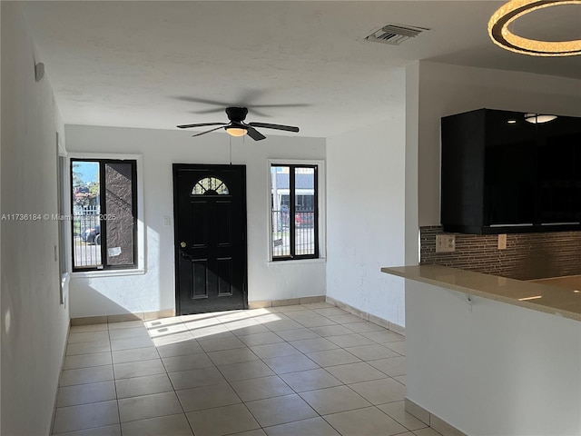 tiled foyer entrance with ceiling fan