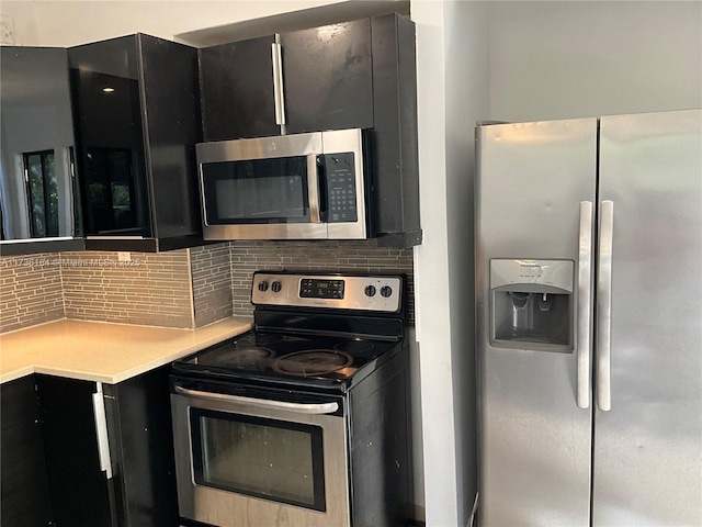 kitchen with backsplash and appliances with stainless steel finishes