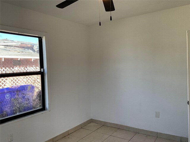 spare room featuring ceiling fan and light tile patterned floors