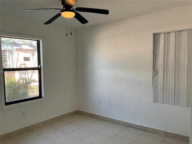 tiled empty room with ceiling fan