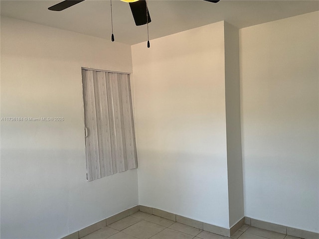 spare room with light tile patterned flooring and ceiling fan