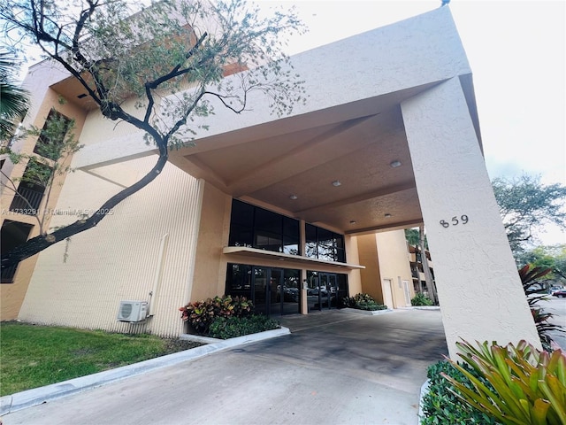 view of building exterior featuring a wall mounted air conditioner