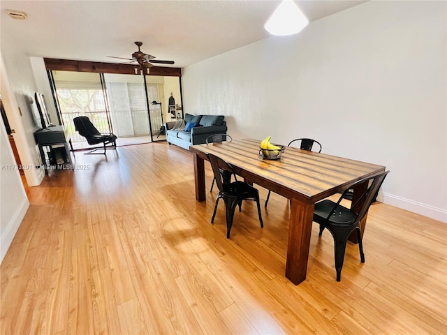 dining space with ceiling fan and light hardwood / wood-style floors