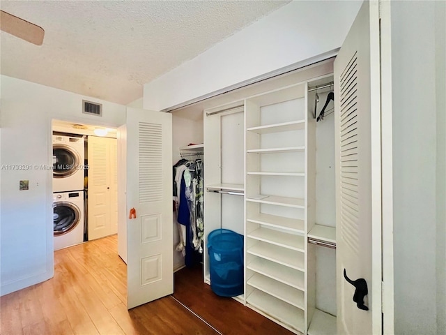 closet featuring stacked washer / dryer