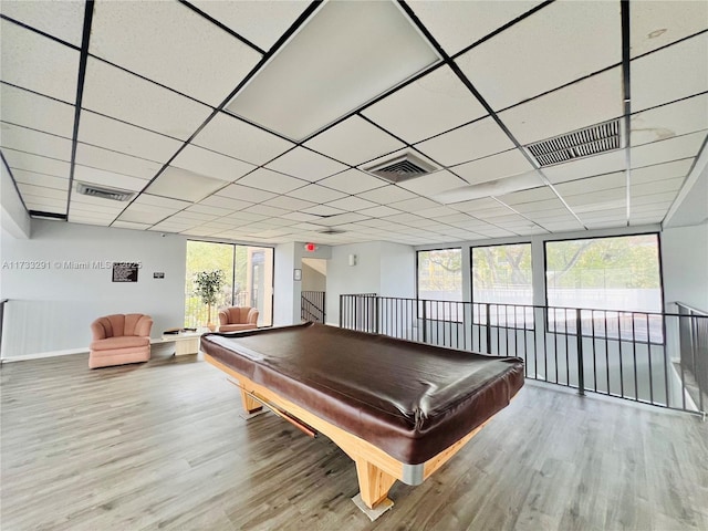 recreation room featuring billiards, a healthy amount of sunlight, a paneled ceiling, and wood-type flooring