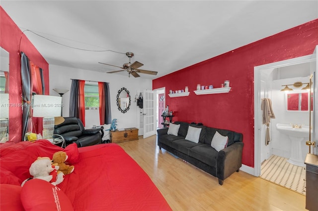 living room featuring french doors, ceiling fan, and hardwood / wood-style floors