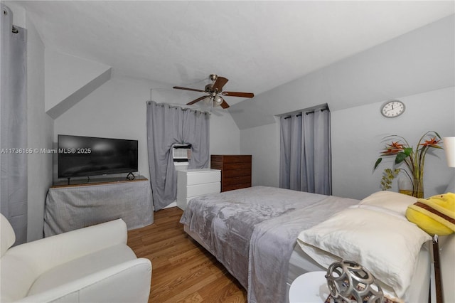 bedroom featuring vaulted ceiling, ceiling fan, and light hardwood / wood-style floors