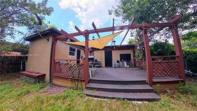 rear view of property featuring a deck