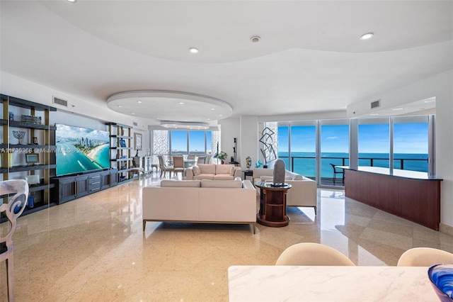 living room with a healthy amount of sunlight and a water view