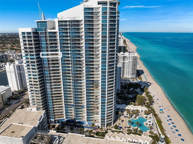 view of building exterior featuring a view of the beach and a water view