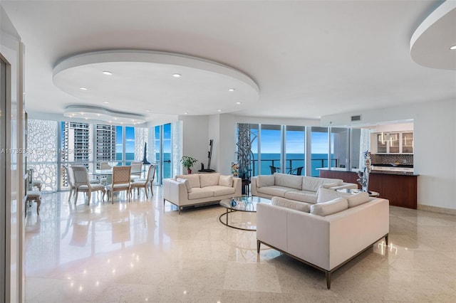 living room with a water view and expansive windows