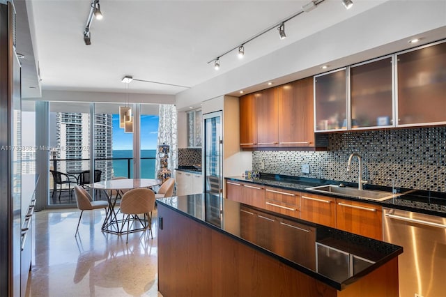 kitchen with sink, dishwasher, backsplash, a water view, and a kitchen island