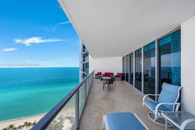 balcony featuring a beach view and a water view