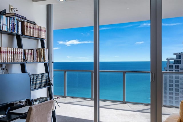 office area with a wealth of natural light, a wall of windows, and a water view