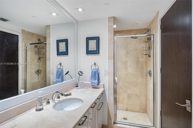 bathroom featuring vanity and an enclosed shower