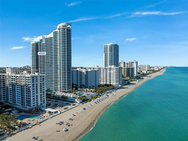 bird's eye view featuring a water view and a beach view