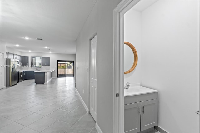 interior space featuring sink and light tile patterned flooring