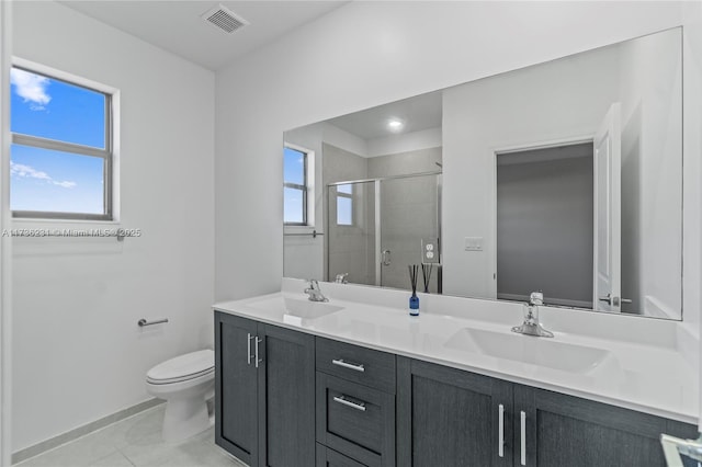 bathroom featuring vanity, a wealth of natural light, an enclosed shower, and toilet