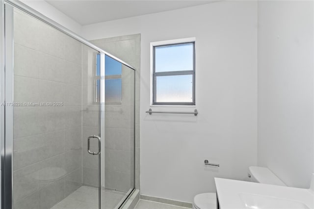 bathroom with vanity, a shower with shower door, and toilet