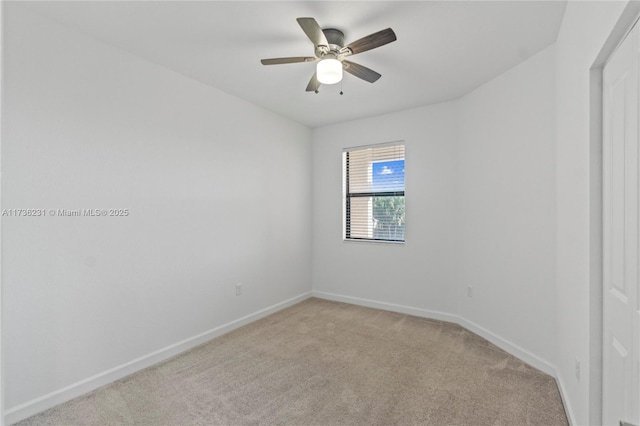 unfurnished room with light colored carpet and ceiling fan