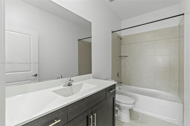 full bathroom featuring tiled shower / bath, tile patterned floors, toilet, and vanity