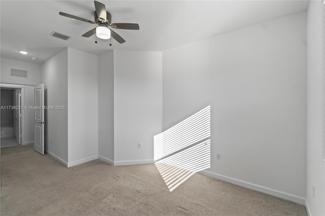 unfurnished room featuring light carpet and ceiling fan