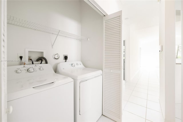 laundry room with separate washer and dryer and light tile patterned floors