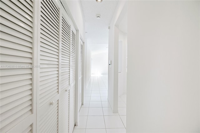 hall featuring light tile patterned flooring