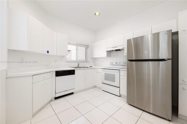 kitchen with white cabinetry, sink, white appliances, and light tile patterned floors