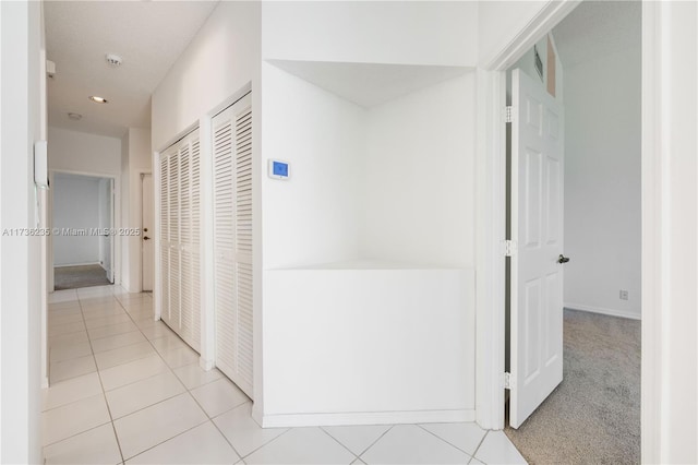 corridor featuring light tile patterned floors