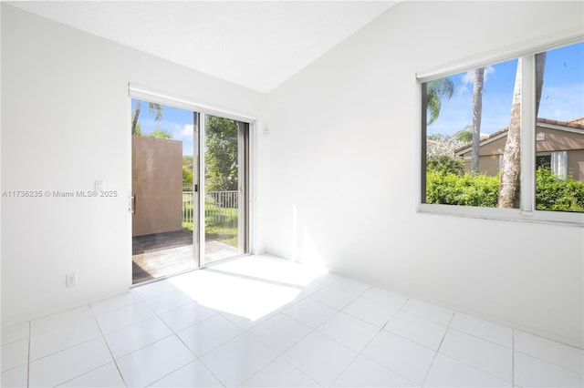 tiled empty room with vaulted ceiling