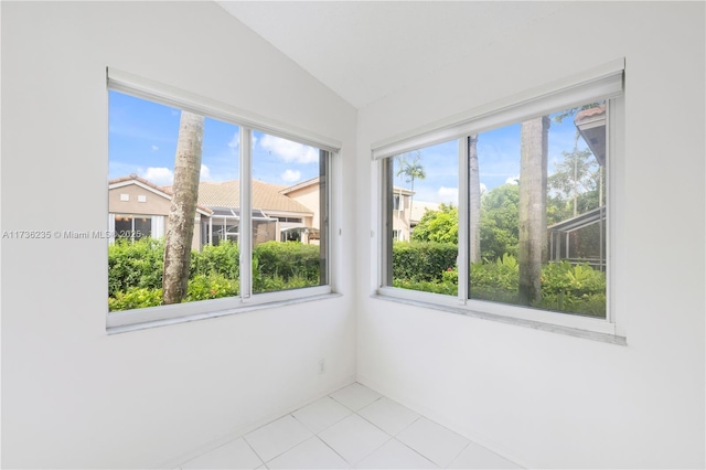 unfurnished sunroom featuring plenty of natural light and vaulted ceiling