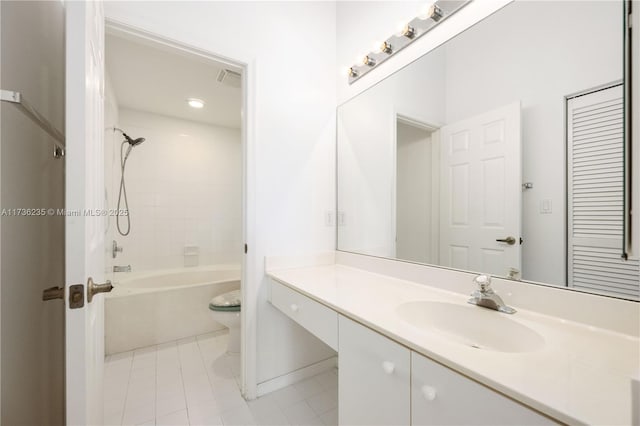 full bathroom featuring tiled shower / bath, vanity, toilet, and tile patterned flooring