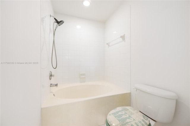 bathroom featuring tiled shower / bath and toilet