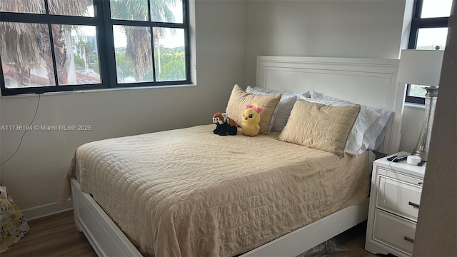 bedroom with dark wood-type flooring