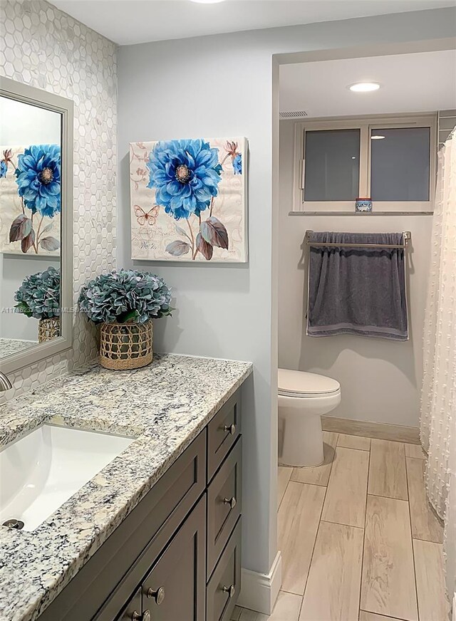 bathroom with vanity and toilet