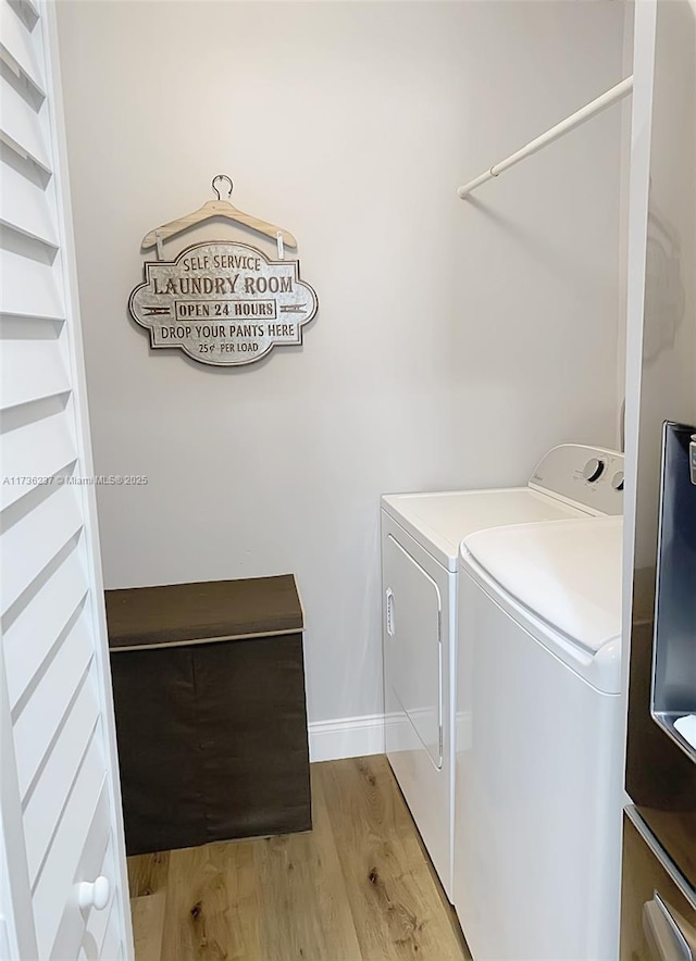 laundry room featuring washer and dryer and light wood-type flooring